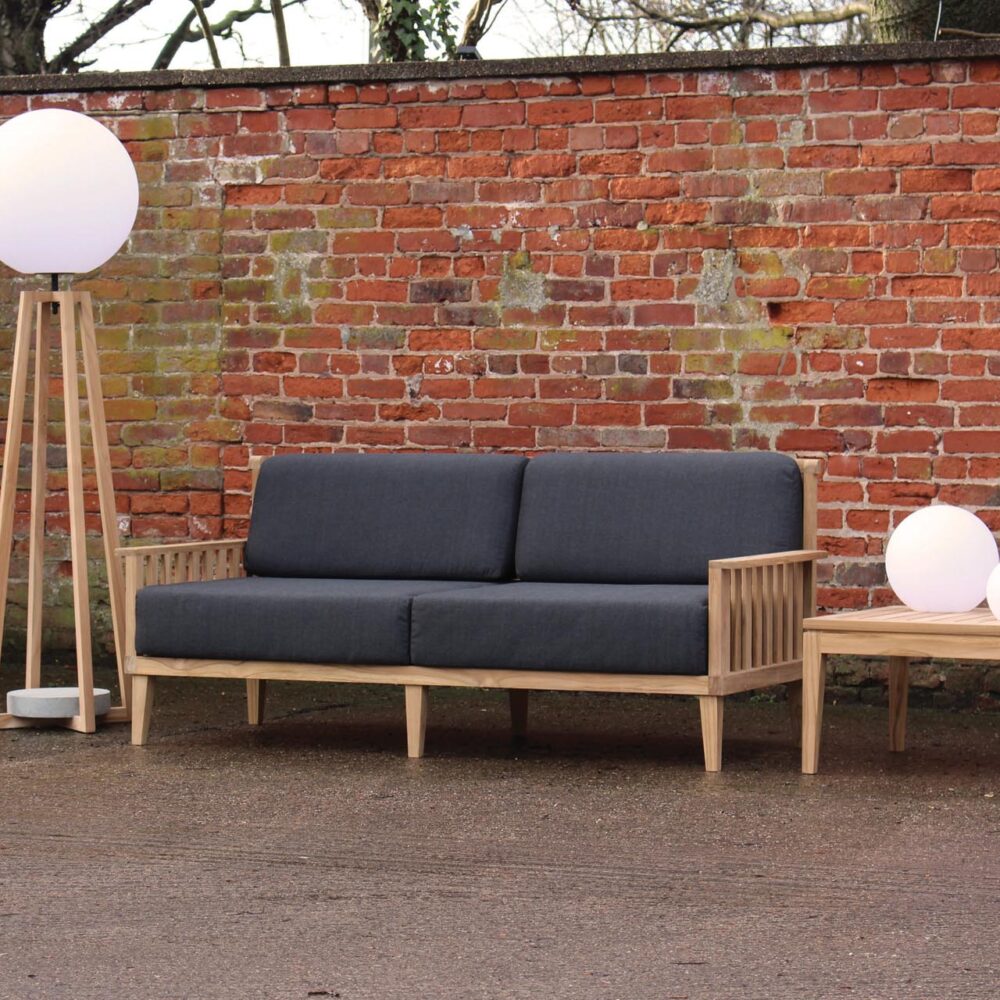 paling large outdoor sofa - teak with upholstered pads, playa lamp, luna lights and menton side table.