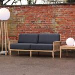 paling large outdoor sofa - teak with upholstered pads, playa lamp, luna lights and menton side table.
