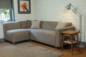 mode sectional seating - example of a corner set up - upholstered in the uk - shown in pelage clay. bruges lamp, shoreditch side table and stitich rug also pictured