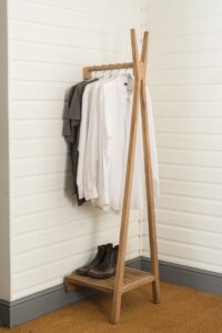 totem wall mounted clothes rail - solid wood clothes rail with lower storage shelf - in situ