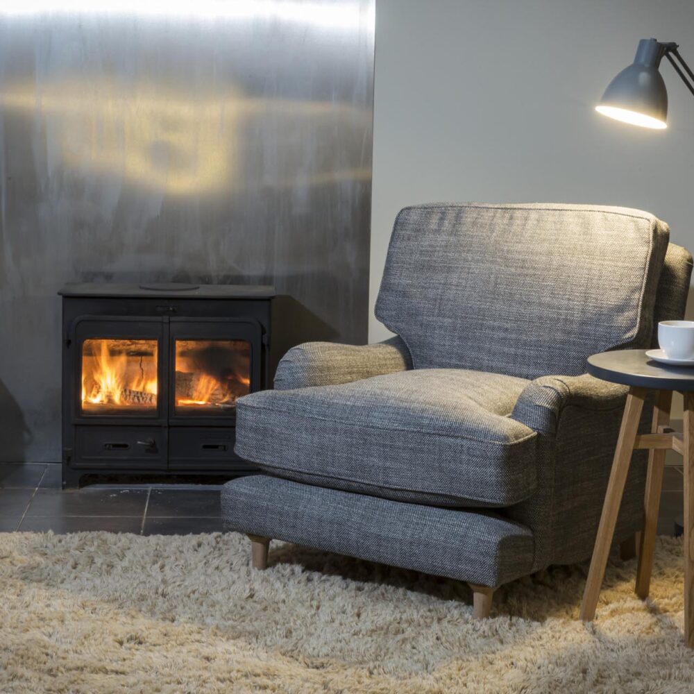 arundel fully upholstered armchair - made in the uk in a choice of fabrics - shown with mane rug + bruge floor lamp